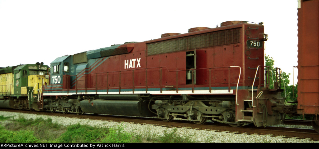 HATX 750 X-CSX 8958 XX-SCL 2053 SD40-2 rebuilt from SD45-2 trails UP 6084 SD60 and CNW 5054 GP50 westbound from CSX Gentilly Yard beside I-10 New Orleans LA 08-18-1996